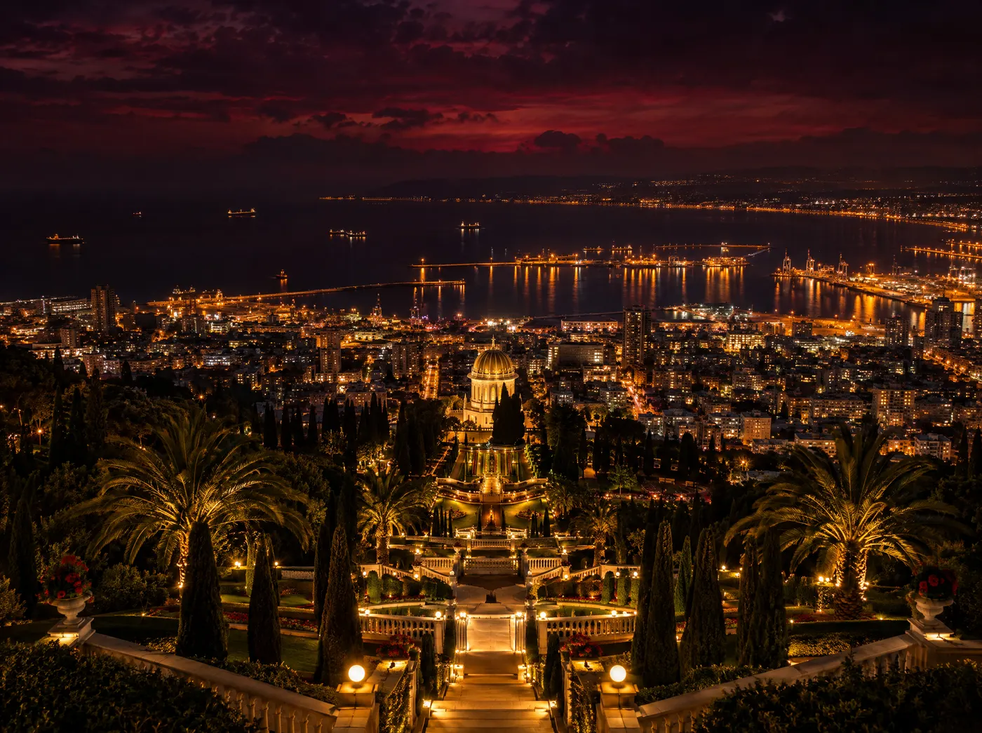 Haifa at night: illuminated terraced gardens and the harbor